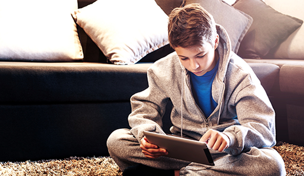 Young boy focusing on his iPad