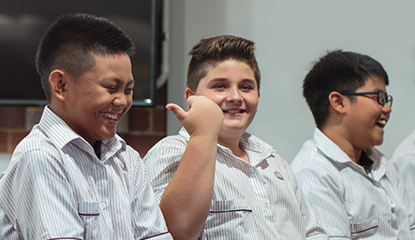 about-mid-year-report Group of three young students happily laughing.