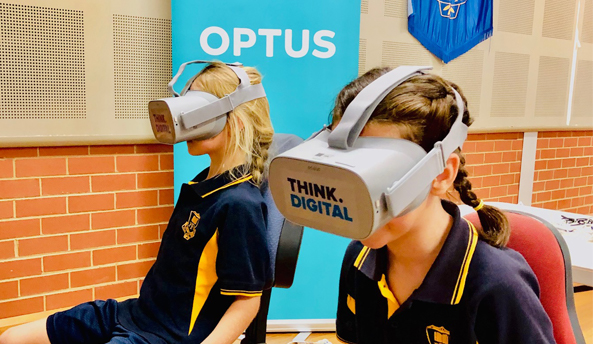 Two school girls enjoying virtual reality headsets at Optus Event in in their school.