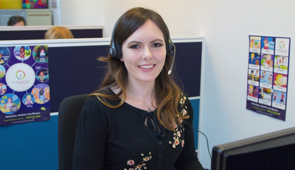 Kids help line counsellor smiling whilst at work.