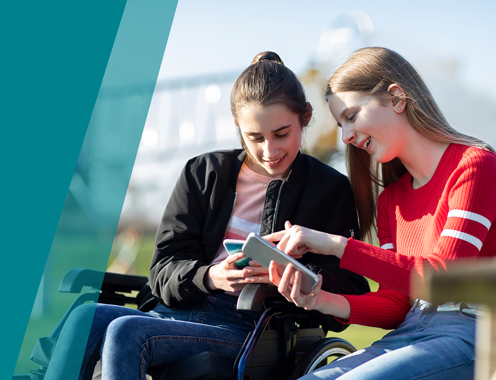 Two Young Women enjoying time together on their mobile phones..