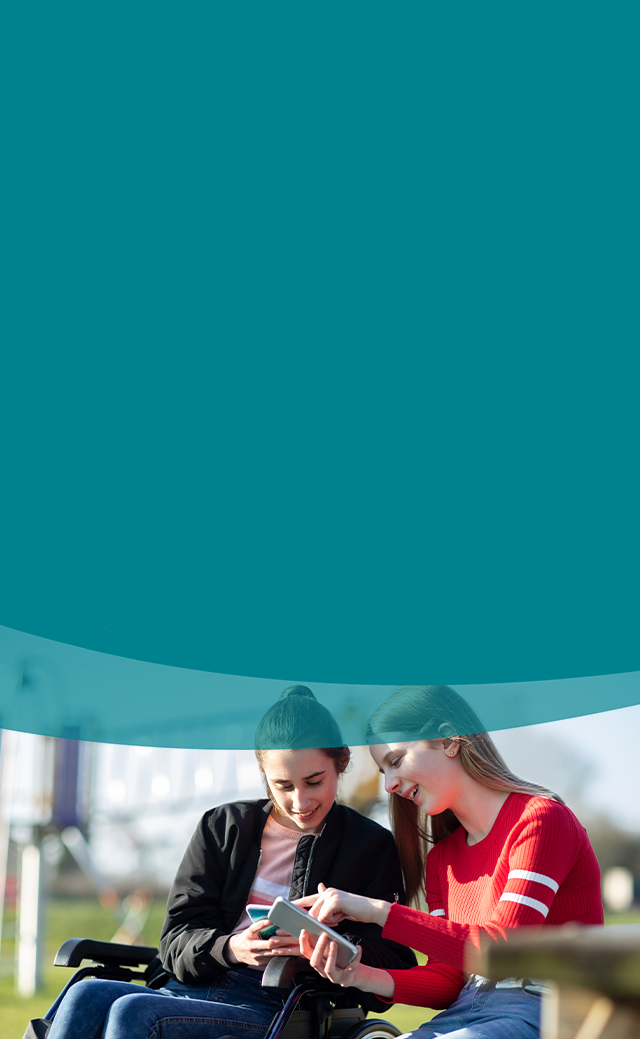 Two Young Women enjoying time together on their mobile phones.