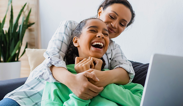 passphrases-family Young woman and her mother enjoying an activity on a laptop inside